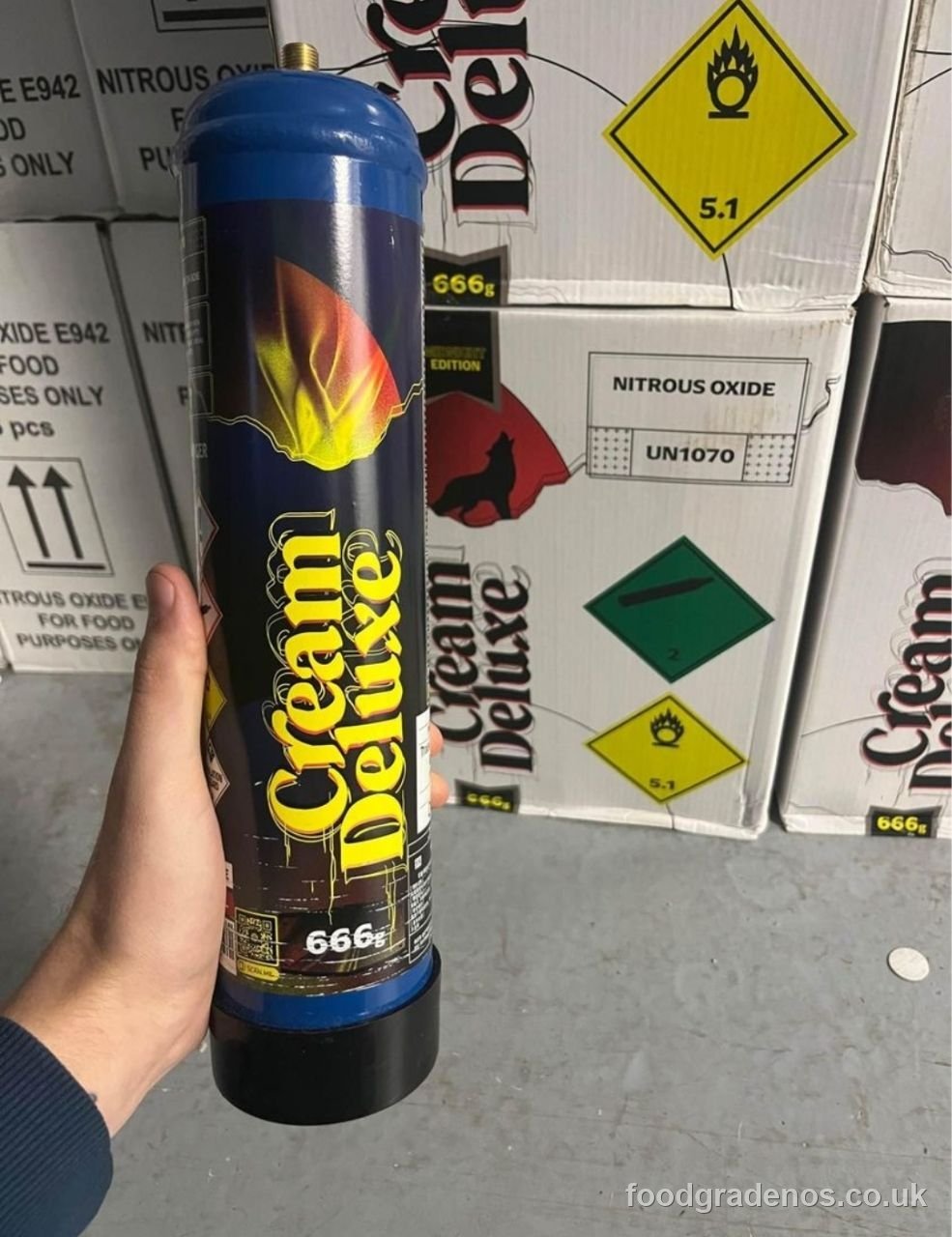 A member of the Food Grade NOS team holding a food-grade nitrous cylinder in the warehouse